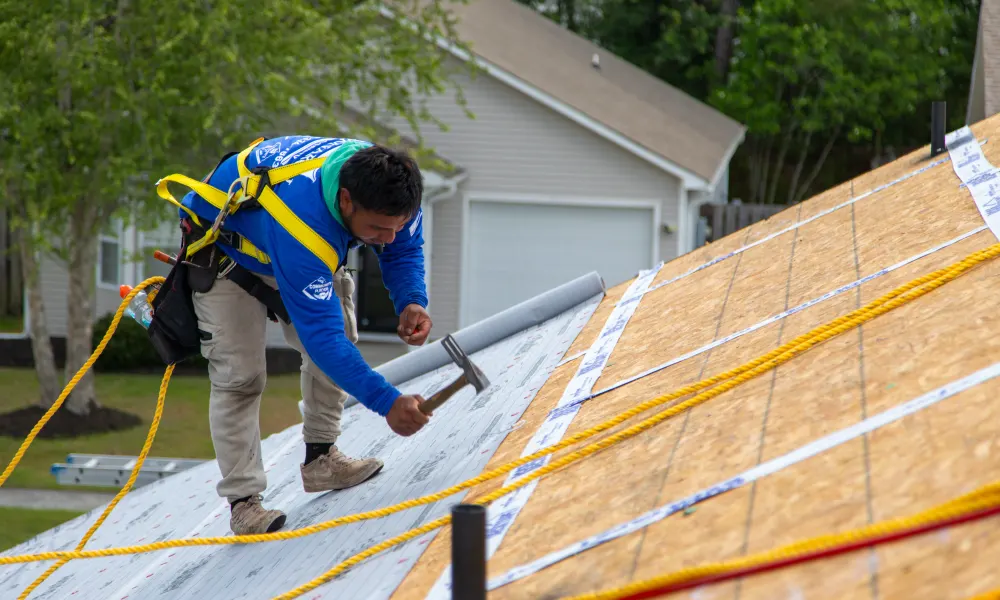 Roofing crew restoring a storm damaged roof